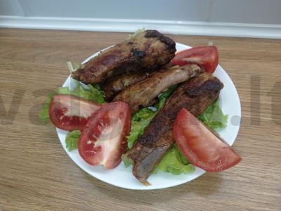 Kepti kiaulienos šonkauliai su svogūnais ir daržovėmis pagrindine nuotrauka