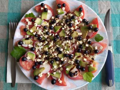 Šviežių daržovių salotos su avokadu, tofu ir juodaisiais serbentais pagrindine nuotrauka