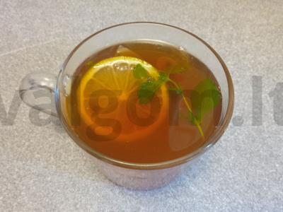 Juodasis arbata su limonu, mėtomis ir medumi pagrindine nuotrauka